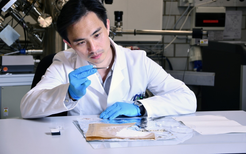 Со-ведущий научный сотрудник Фей Пан исследует кусок перевязочного материала для ран.